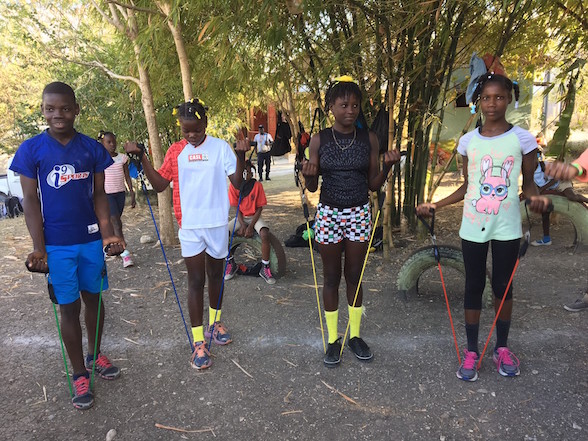 Jean Tassy, Bynia, Kattie and Mada use the resistance bands for the first time.